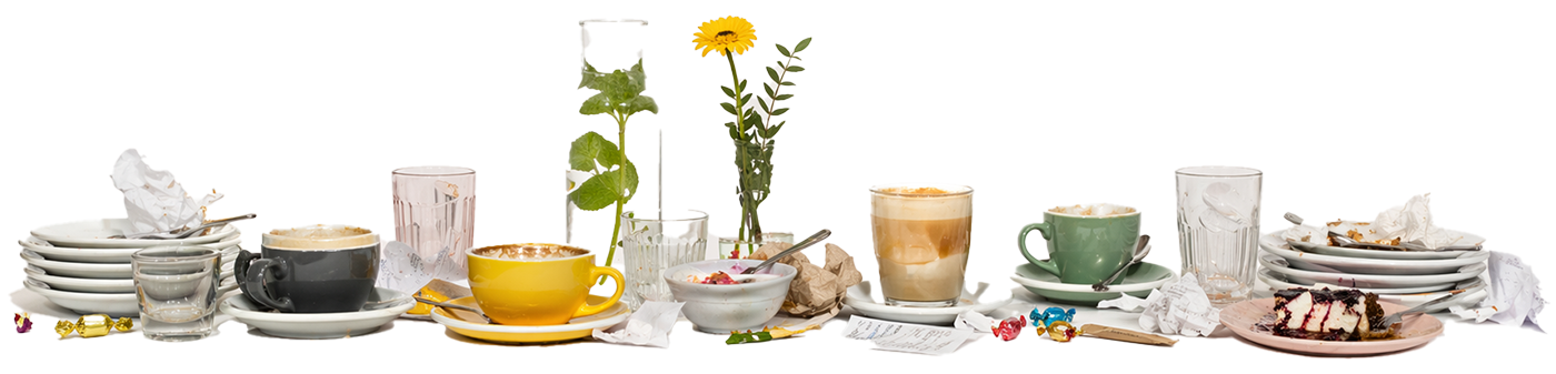 The remnants of a good time at a cafe, without the people. Stacks of used plates, empty cups and half-eaten cakes, photographed side-on as a wide photograph against a blank background.